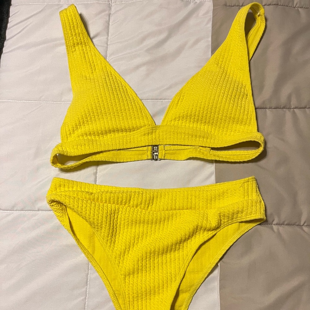 Large bright yellow swimsuit.